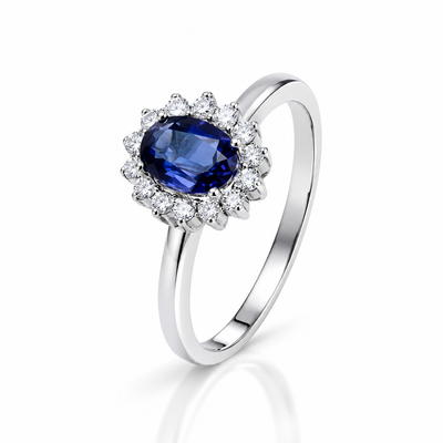 Anillo de zafiro azul con halo de diamantes en oro blanco
